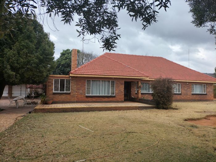 Spacious 4-bedroom house with pool, double garages, and staff quarters in Stilfontein Ext 4. For Sale.