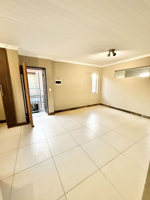 Three-bedroom townhouse in Pretoria West with playground, laundry, and double parking. For Sale.