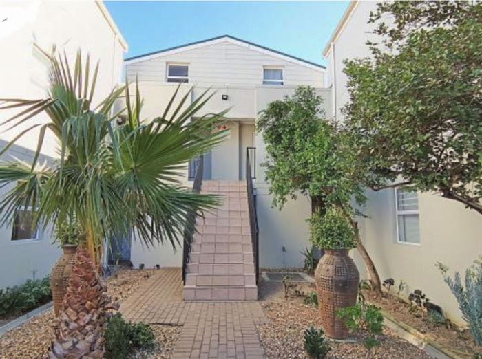 2-Bedroom Apartment For Sale in Whispering Pines with terrace, pool, and parking.