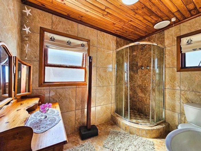 For Sale: 4-bedroom house in Herolds Bay with ocean views, garden, and braai area.