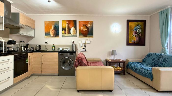 Ground floor apartment for sale in Gansbaai Central with secure parking and patio.