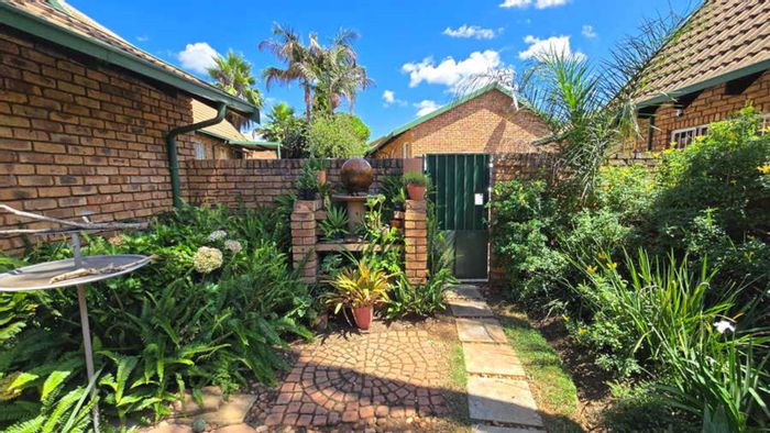 For Sale: Garsfontein Townhouse with garden, loft, generator, and building plans.