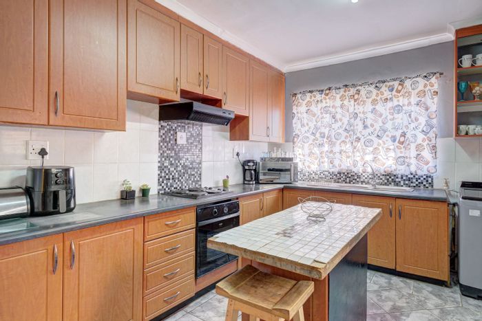 For Sale: 4-Bedroom House in Booysen Park with double garage and braai area.