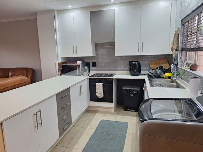 Townhouse for Sale in Faerie Glen: 2 beds, double garage, pool, and braai area.