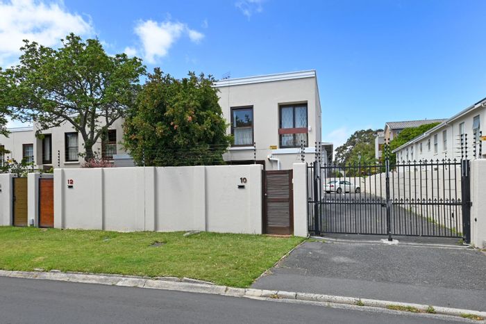 For Sale: Kenilworth Townhouse with private garden, garage, and three bedrooms.