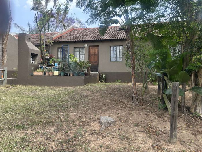 2-Bedroom Townhouse in West Acres For Sale with garden, braai, and secure parking.