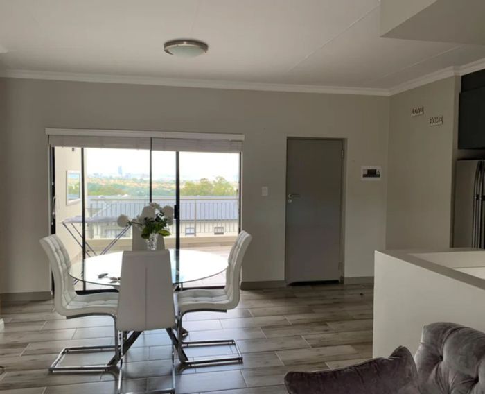 2-Bedroom House in Carlswald To Rent with balcony, communal pool, and covered parking.