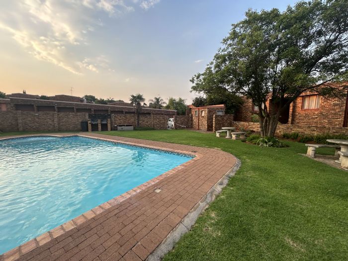 2 Bedroom Apartment For Sale in Zwartkop with pool, braai area, and garage.