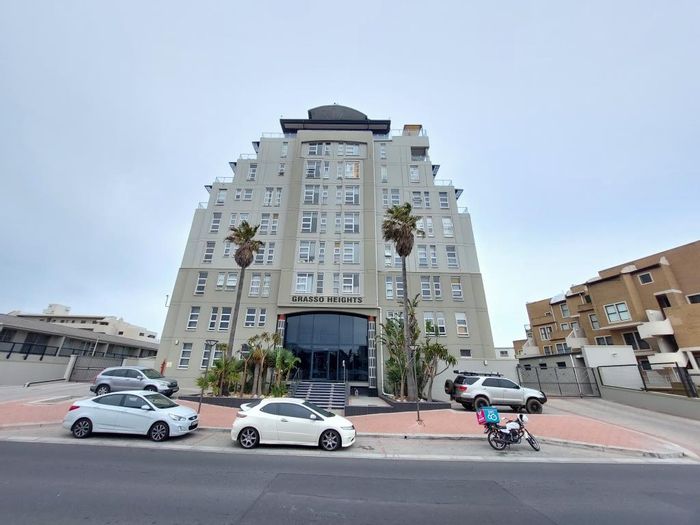 Two-bedroom apartment in Bloubergrant with balconies, parking, and beach access. To Rent.